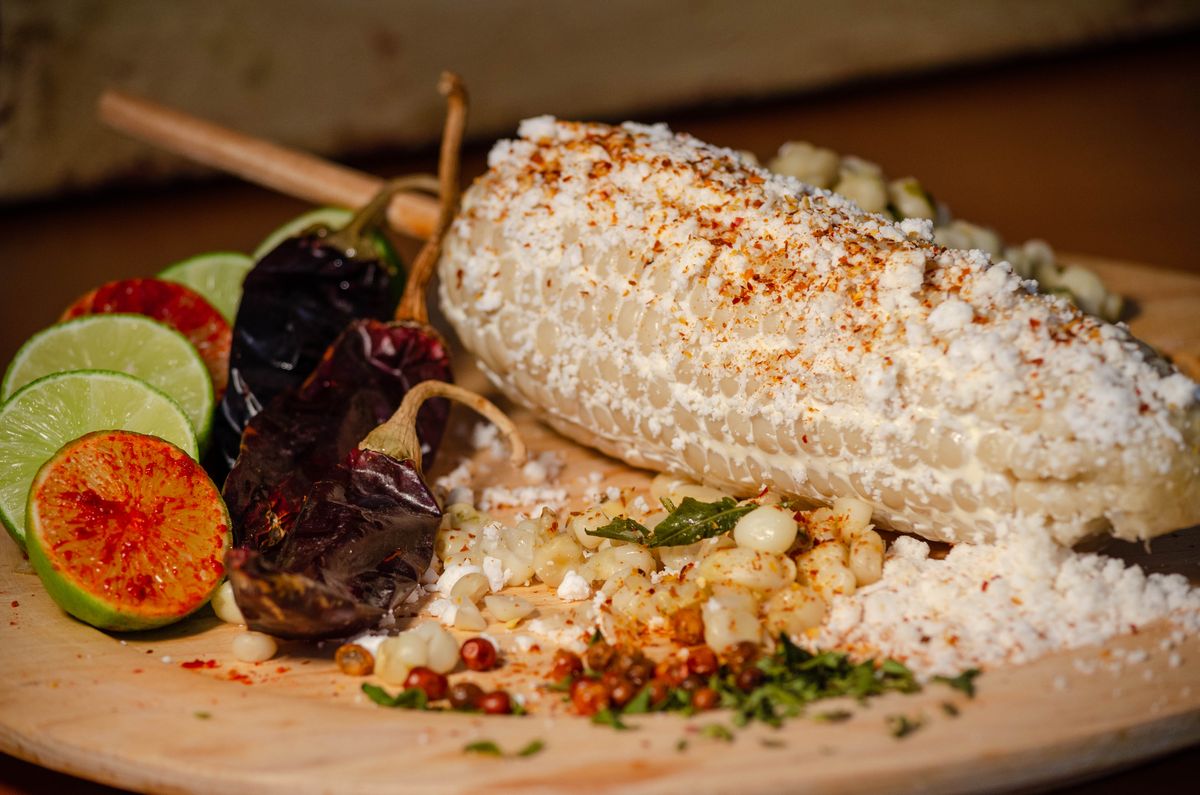 Grilled elote with tangy lime and chili toppings