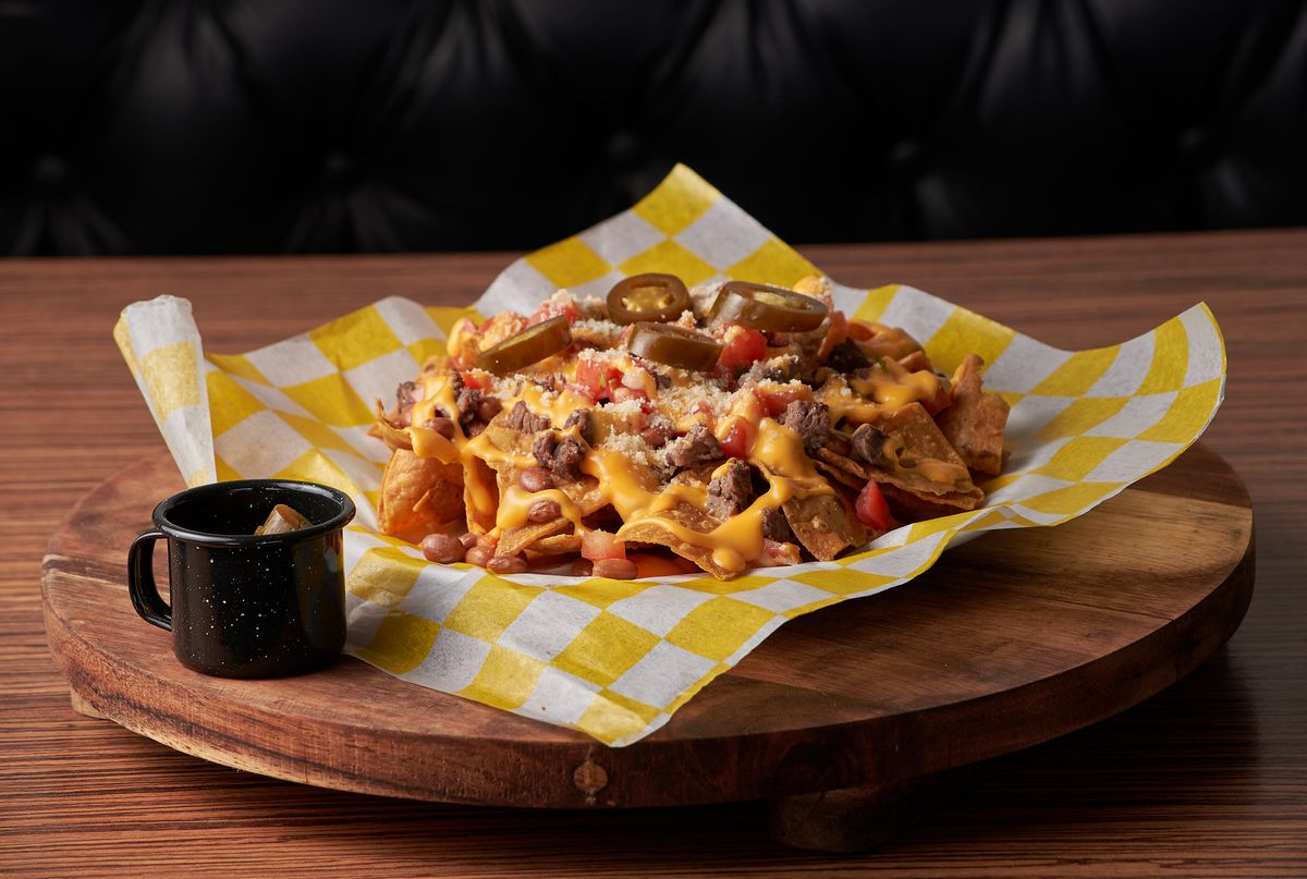 Loaded carne asada nachos topped with melted cheese