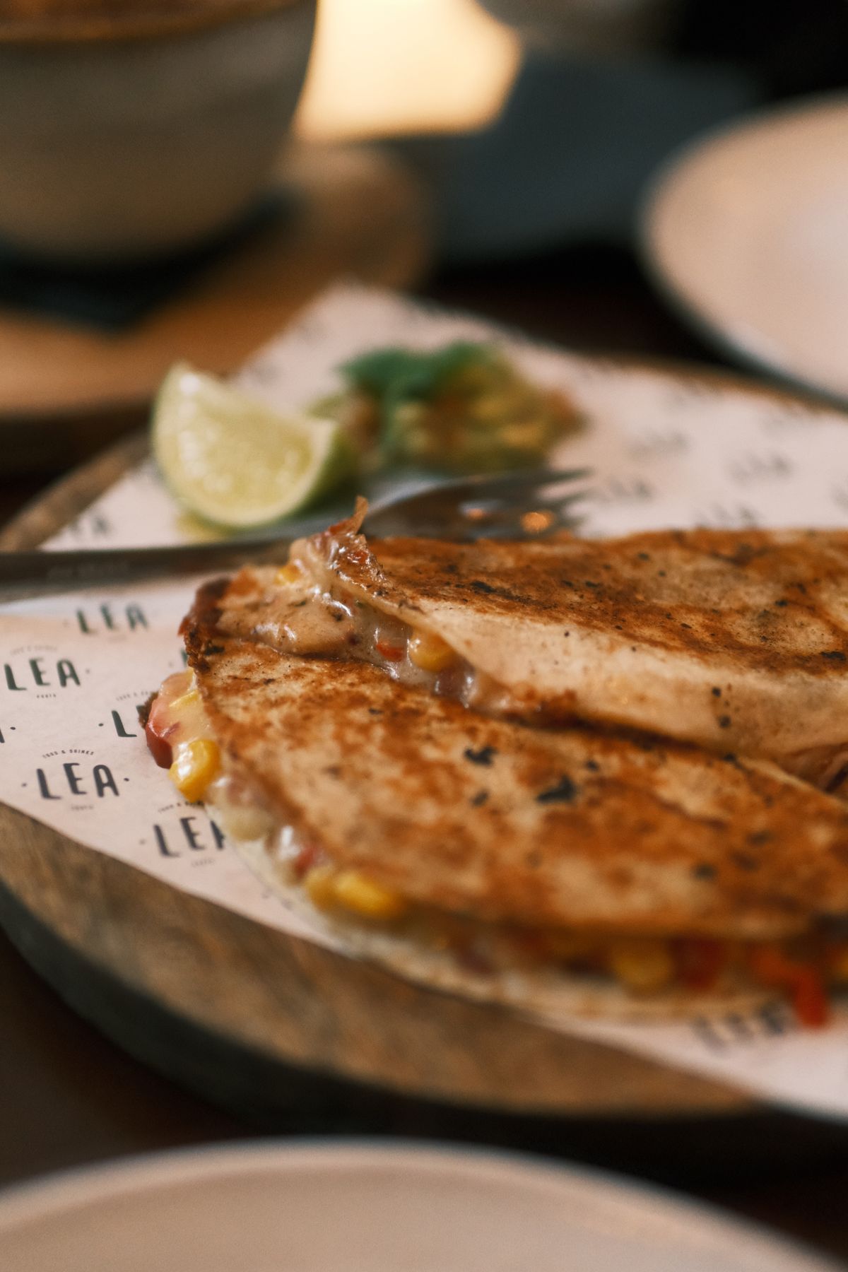 Crispy quesadilla topped with guacamole and lime